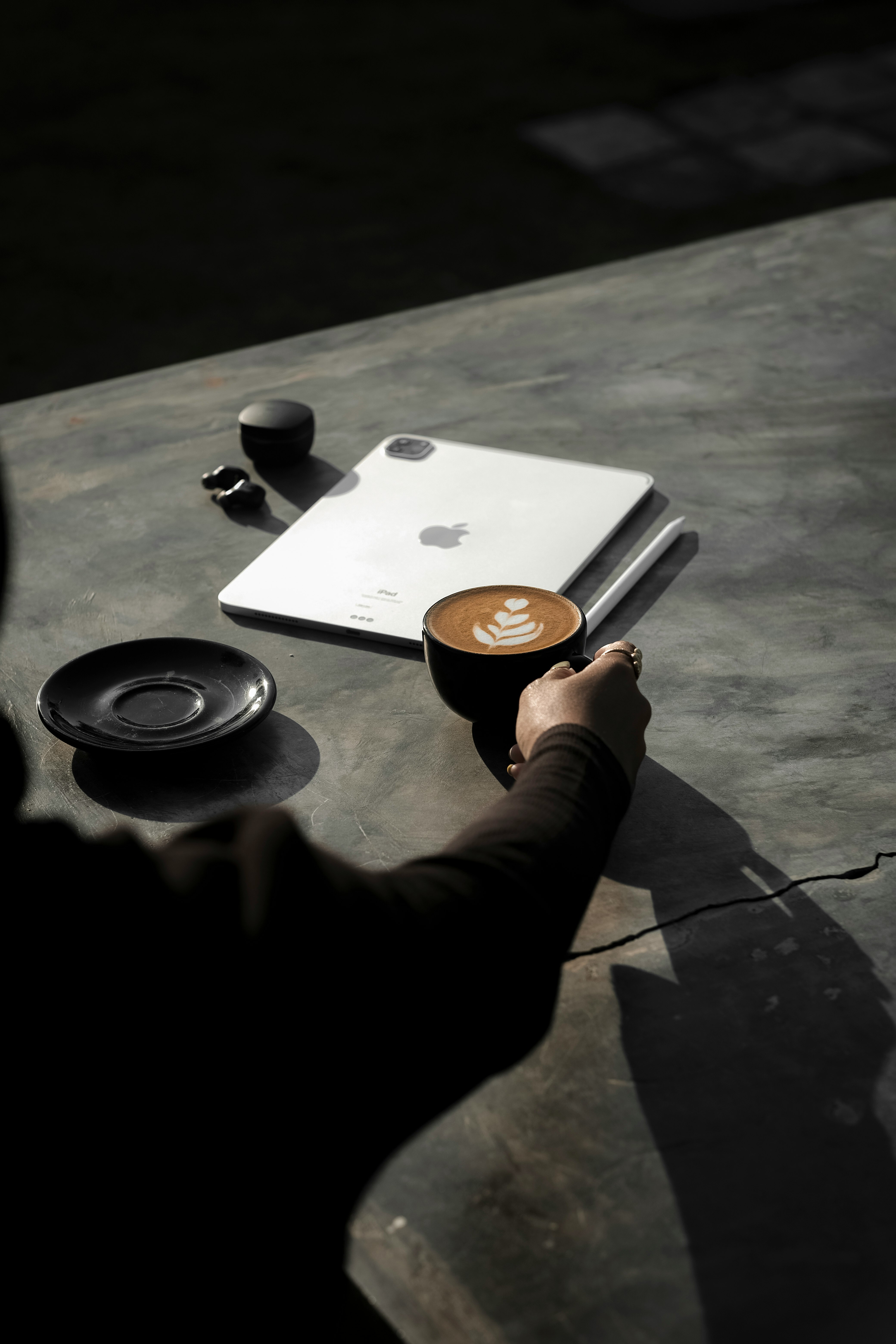 person holding white and black ceramic mug